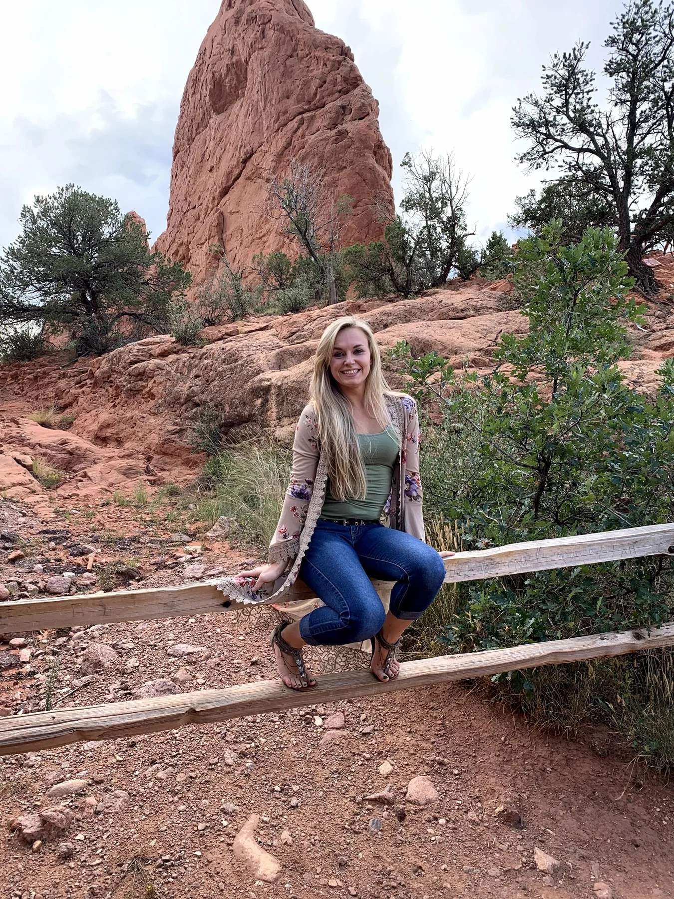 Ashley surrounded by the red rock landscape in Colorado.