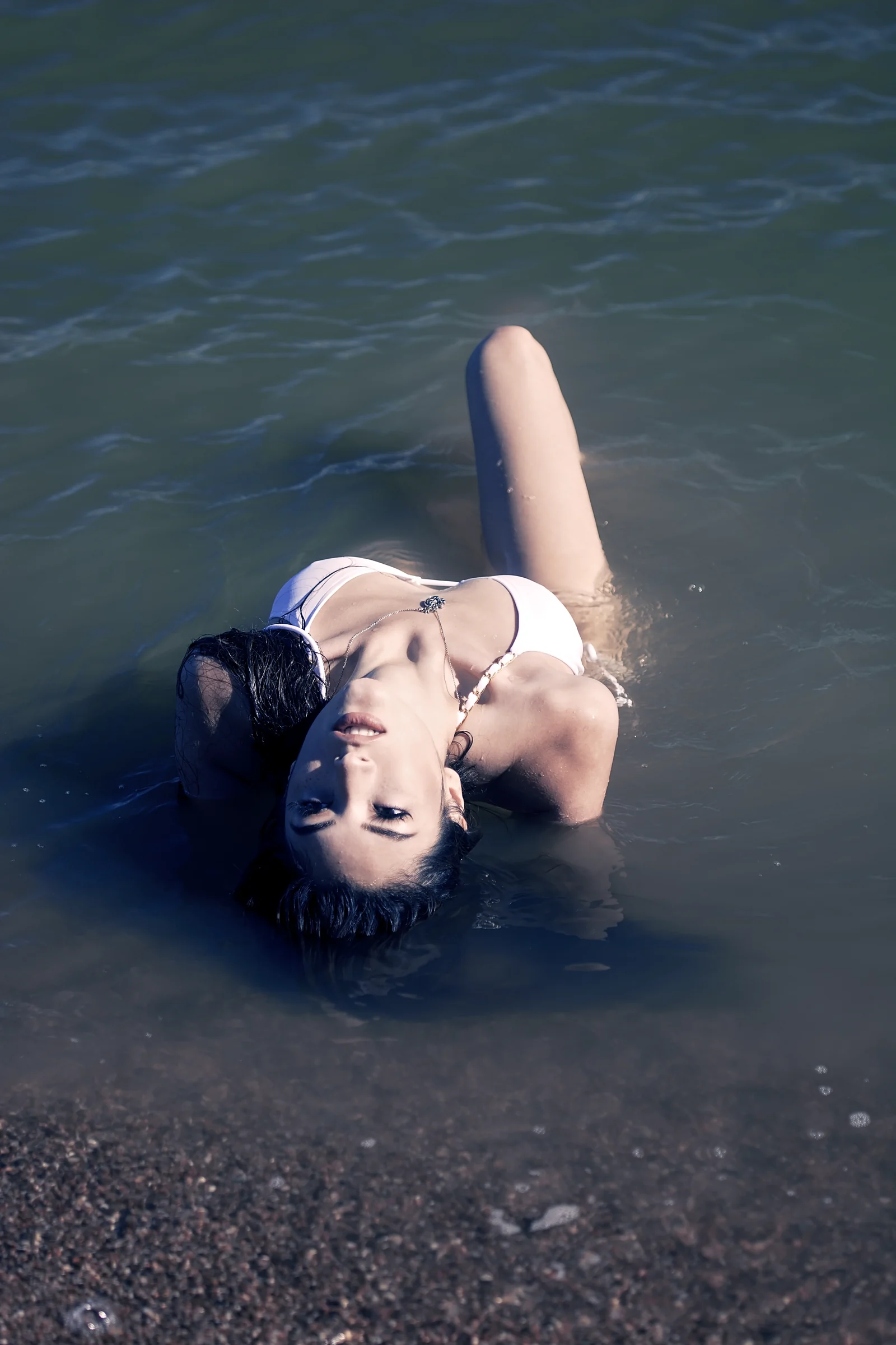 Cinematic stylized portrait floating in dark water.